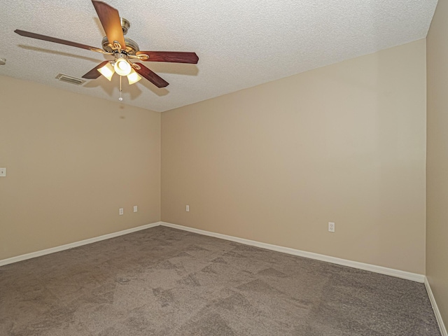 spare room featuring ceiling fan, carpet floors, and a textured ceiling