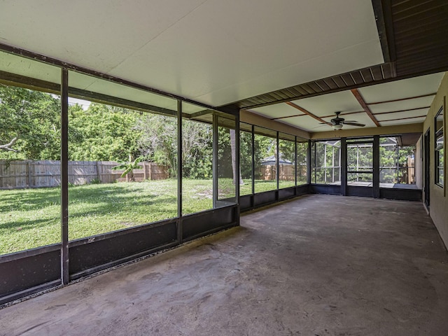 unfurnished sunroom featuring ceiling fan