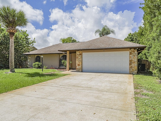 ranch-style home featuring a garage and a front yard