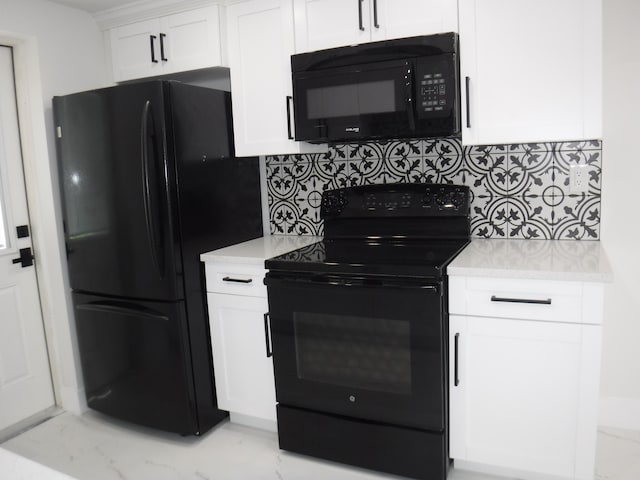 kitchen with backsplash, black appliances, and white cabinets