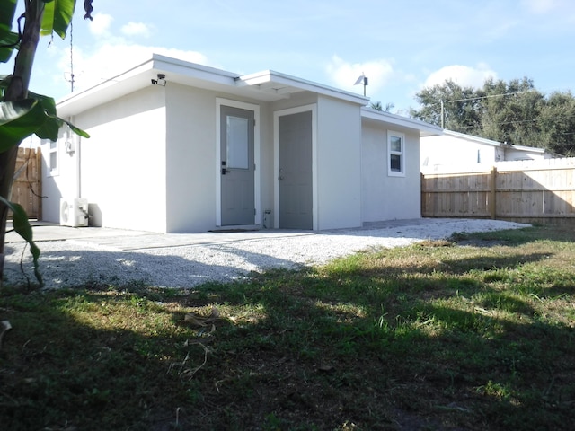 rear view of house featuring a yard