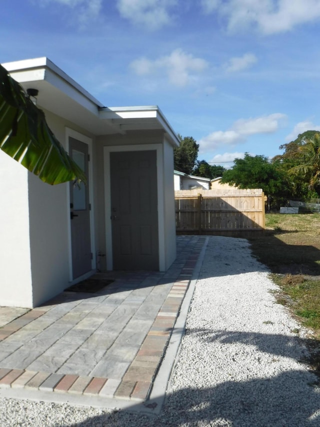 view of side of property with a patio area