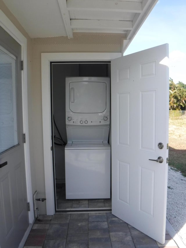 laundry room with stacked washer and clothes dryer