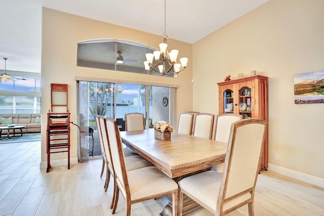 dining room with ceiling fan with notable chandelier and light wood-type flooring