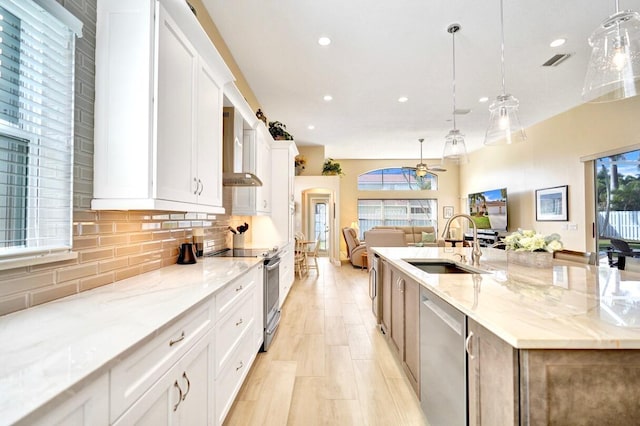 kitchen featuring pendant lighting, sink, white cabinets, and appliances with stainless steel finishes