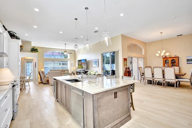 kitchen with white cabinetry, pendant lighting, a spacious island, and appliances with stainless steel finishes