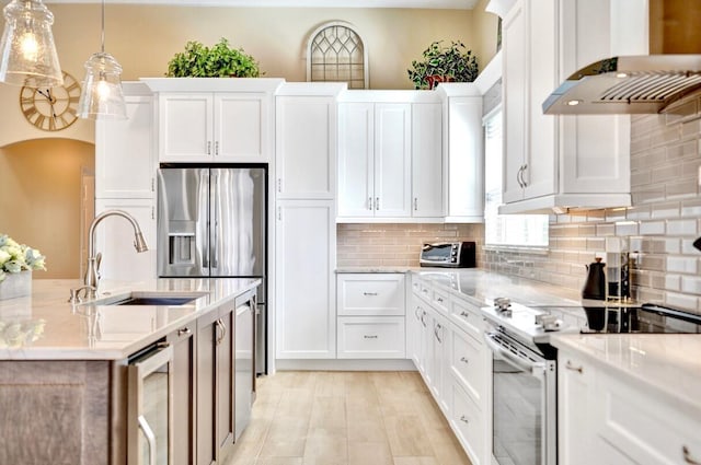 kitchen featuring white cabinetry, appliances with stainless steel finishes, and ventilation hood