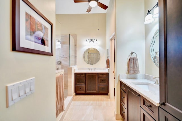 bathroom featuring vanity, a tile shower, and ceiling fan