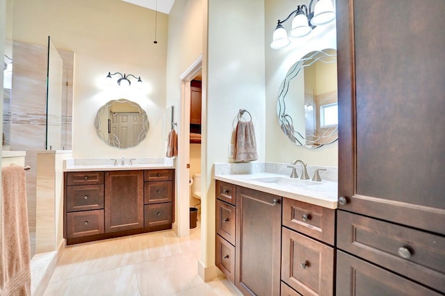 bathroom featuring tile patterned flooring, vanity, and toilet