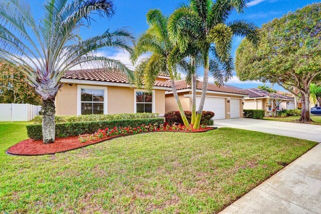 mediterranean / spanish-style house with a garage