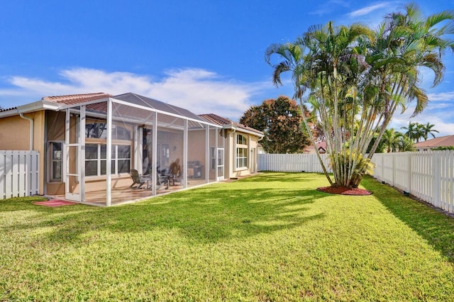 view of yard with a patio and glass enclosure