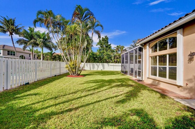 view of yard featuring glass enclosure