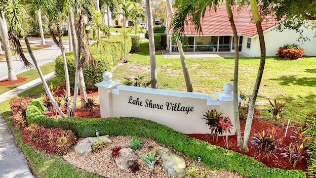 community / neighborhood sign with a yard