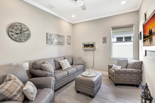 living room with ornamental molding and light wood-type flooring