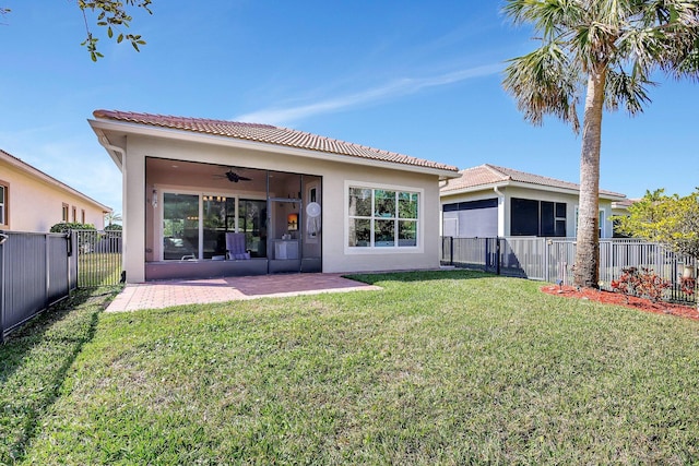 rear view of property featuring a patio, a yard, and ceiling fan