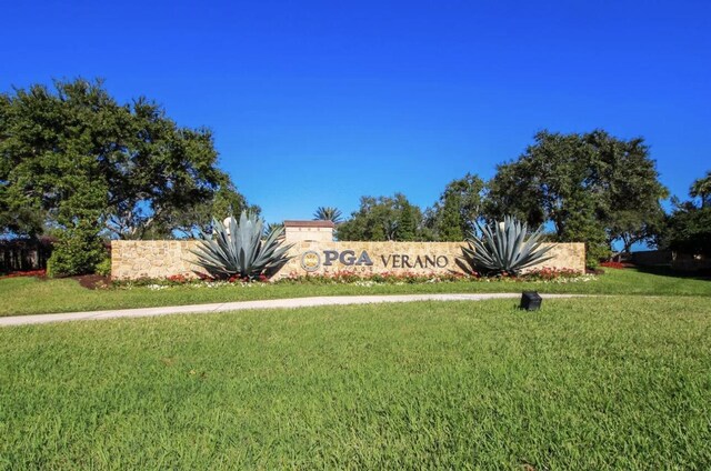 community / neighborhood sign with a yard