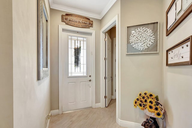 doorway to outside with ornamental molding and light hardwood / wood-style floors