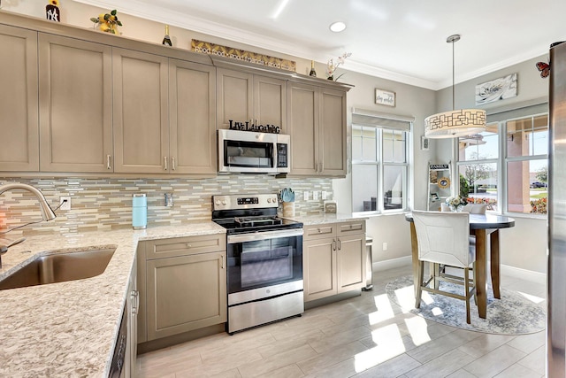 kitchen with sink, hanging light fixtures, ornamental molding, appliances with stainless steel finishes, and backsplash