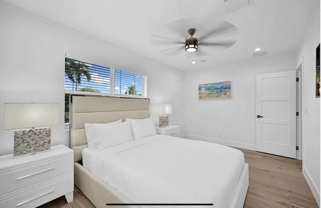 bedroom with light hardwood / wood-style flooring and ceiling fan