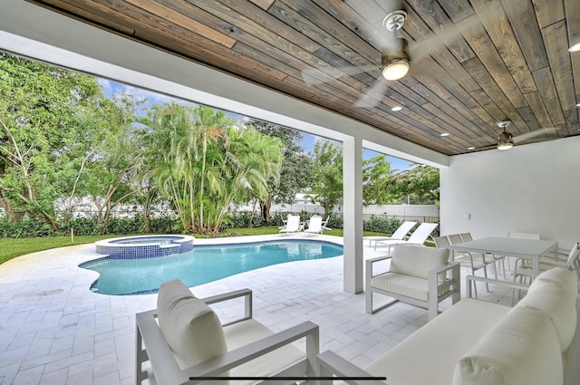 view of pool featuring an in ground hot tub, outdoor lounge area, ceiling fan, and a patio area