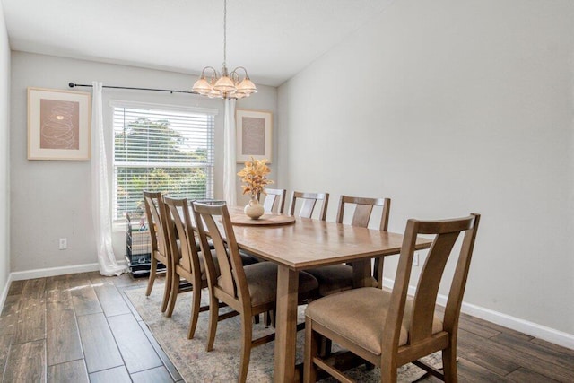 dining room featuring dark hardwood / wood-style floors and a chandelier