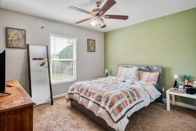 bedroom featuring ceiling fan and light carpet