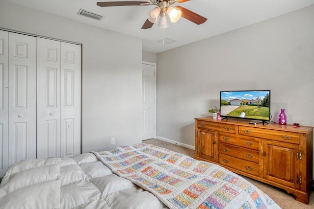 bedroom featuring ceiling fan, light colored carpet, and a closet