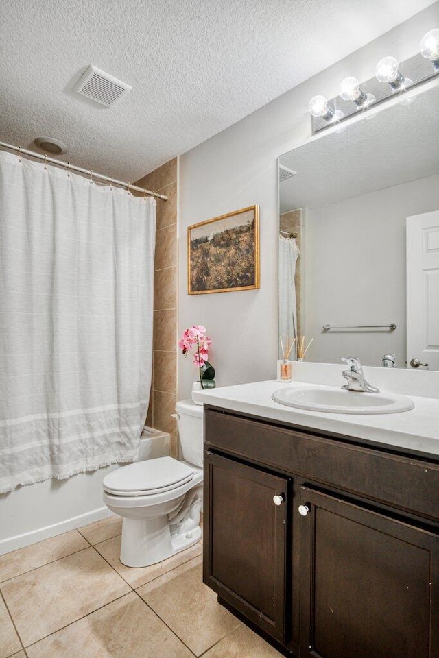 full bathroom with shower / bath combo, vanity, a textured ceiling, tile patterned floors, and toilet