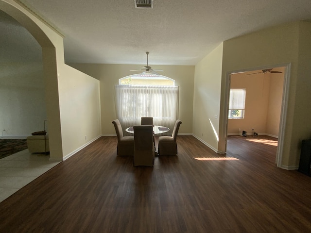 dining room with ceiling fan, a textured ceiling, and dark hardwood / wood-style flooring