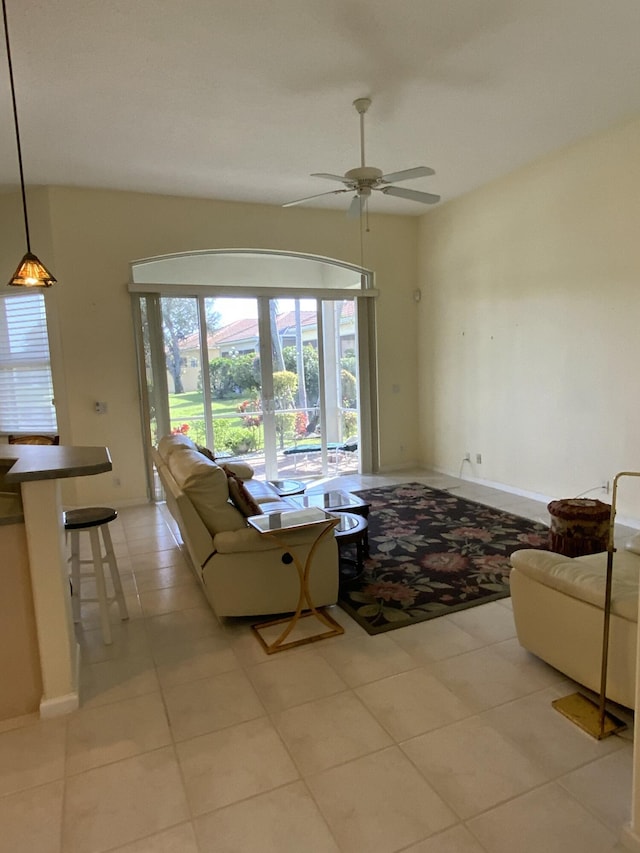 unfurnished living room with light tile patterned flooring, ceiling fan, and lofted ceiling