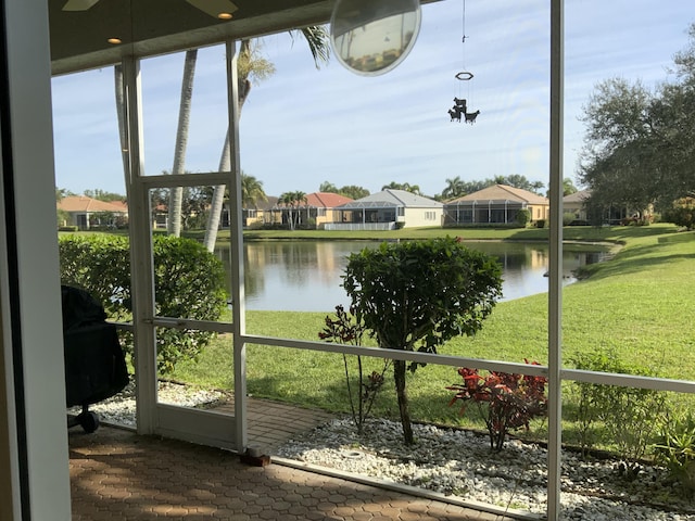 sunroom / solarium with a water view