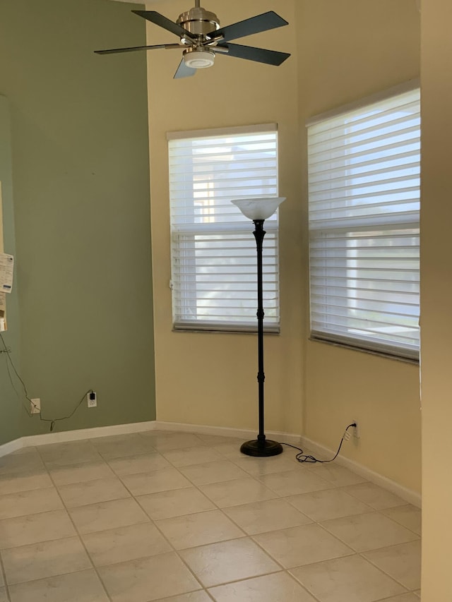 unfurnished room with light tile patterned floors and ceiling fan