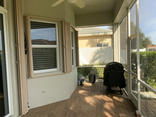 sunroom featuring ceiling fan