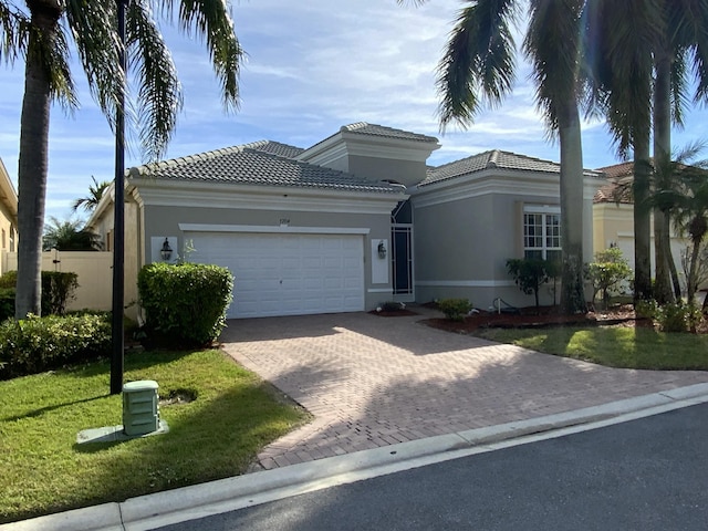 view of front of house featuring a garage and a front lawn