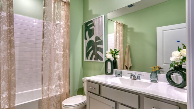 full bathroom with vanity, shower / bath combination with curtain, and toilet