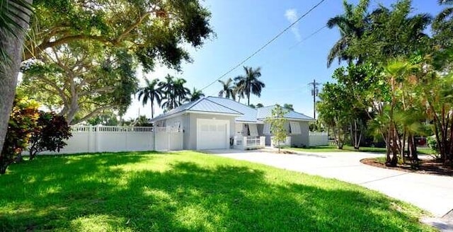 single story home featuring a garage and a front yard