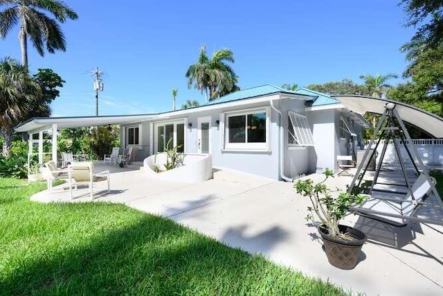 rear view of property featuring a patio area