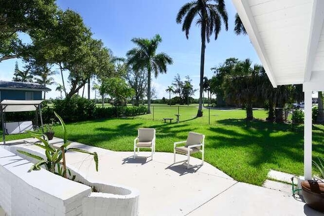 view of home's community with a yard and a patio