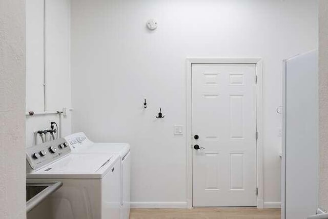 clothes washing area with washer and dryer