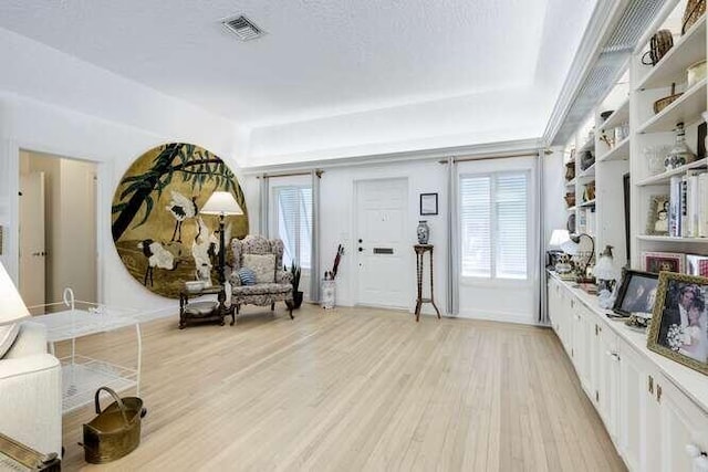 sitting room featuring a healthy amount of sunlight, a textured ceiling, and light wood-type flooring