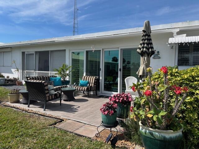 rear view of house with a yard and outdoor lounge area