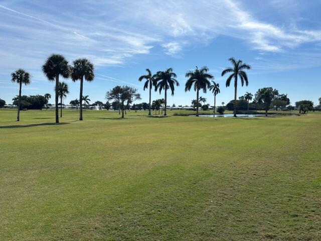 surrounding community featuring a lawn and a water view