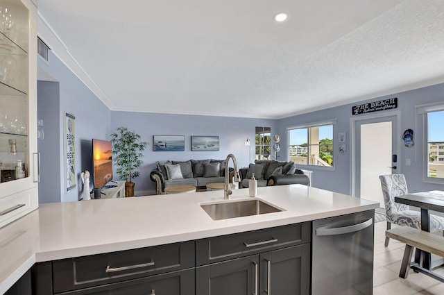 kitchen featuring sink, crown molding, a textured ceiling, light tile patterned flooring, and stainless steel dishwasher