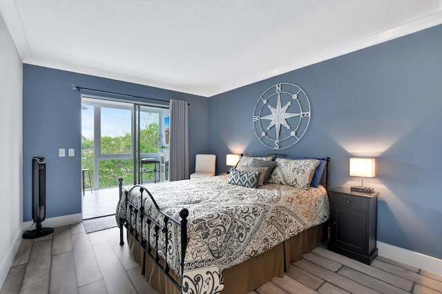 bedroom featuring access to outside, ornamental molding, and light hardwood / wood-style floors