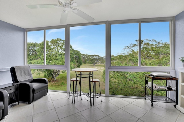 sunroom featuring ceiling fan