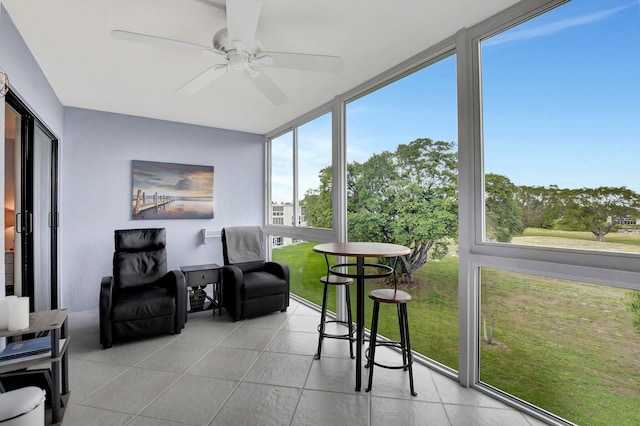 sunroom featuring ceiling fan