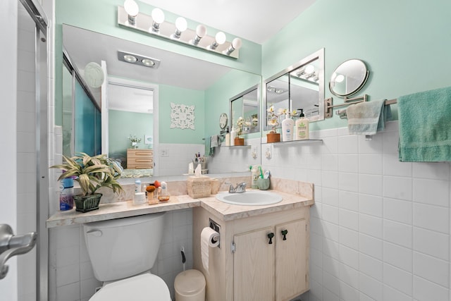 bathroom featuring tile walls, vanity, and toilet