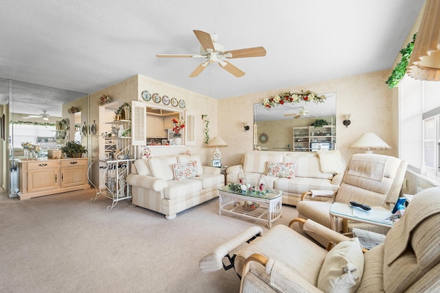 carpeted living room with a textured ceiling and ceiling fan