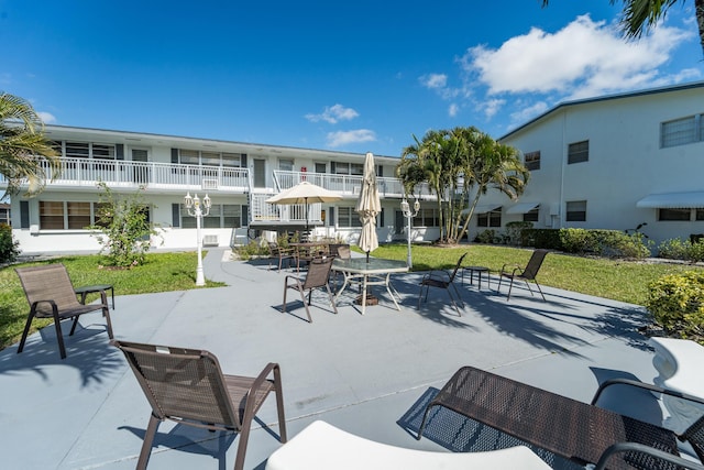 surrounding community with a yard and a patio