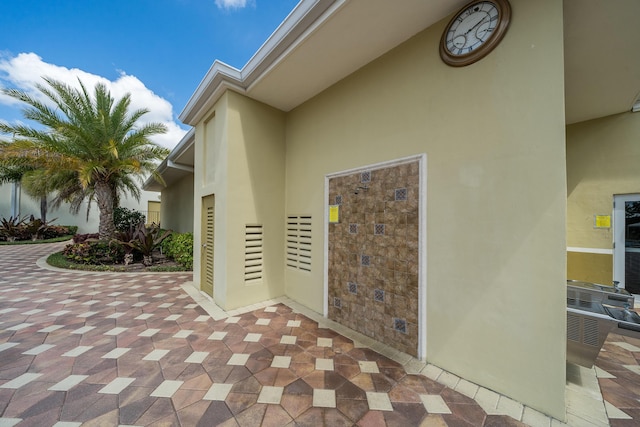 view of exterior entry featuring a patio